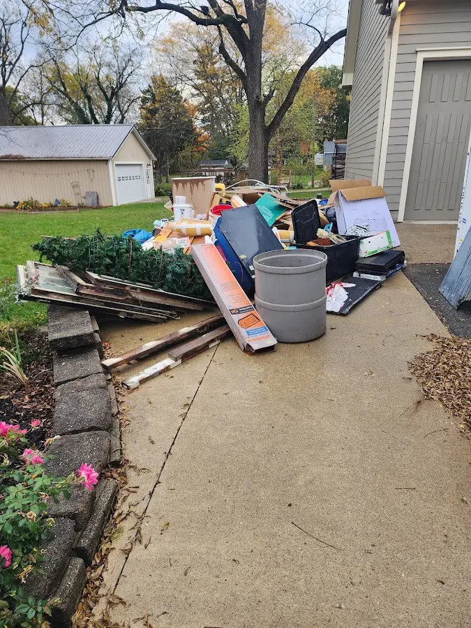 Dumpster being loaded with debris for 3 Yard Dumpster Rental in Bremerton